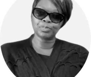 Frances Palmer-Thompson A black and white photo of a medium dark skin tone woman with a warm smile